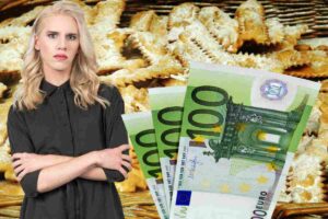 Una donna perplessa, alcune banconote da 100 euro e sullo sfondo le chiacchiere